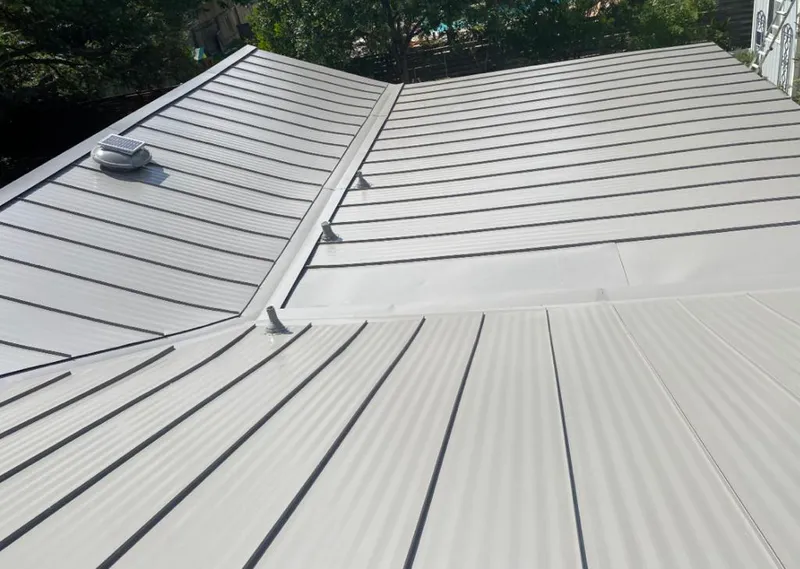 Solar attic fan installed on a metal roof for Roof Ventilation in Hamlet